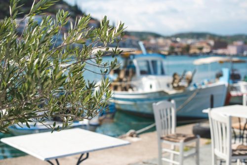 Typical,Greek,Restaurant,And,Fish,Boat,On,The,Background.,Greece,
