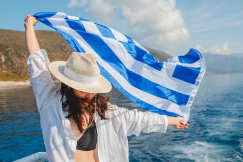 Woman,With,Greece,Flag,At,Cruise,Boat,Lefkada,Island,Greece